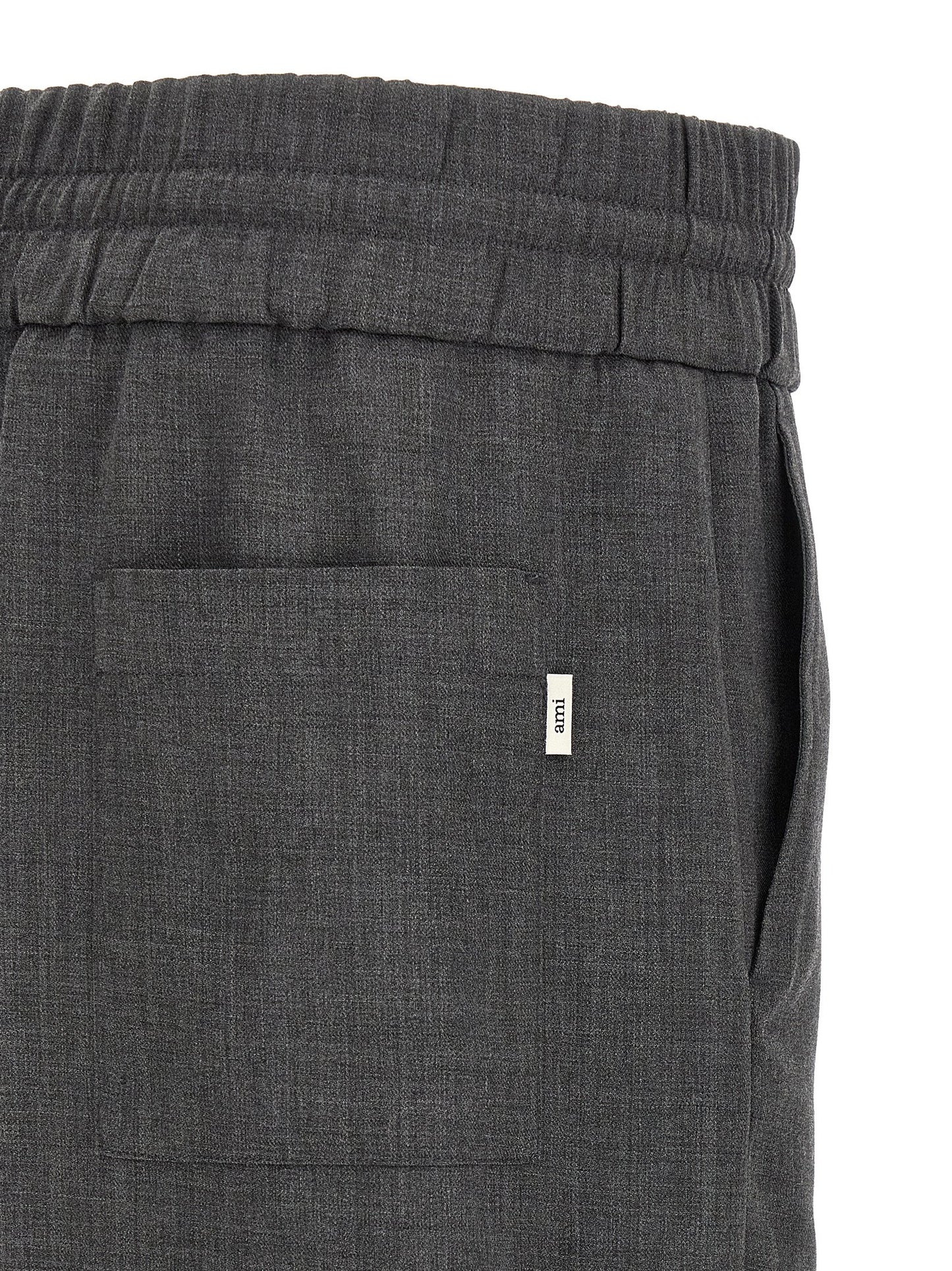 Trousers by Ami Paris for men in virgin wool gray & signature features a artisanal silhouette, showcasing a sophisticated relaxed-fit with a long and high rise for a artisanal finish.
