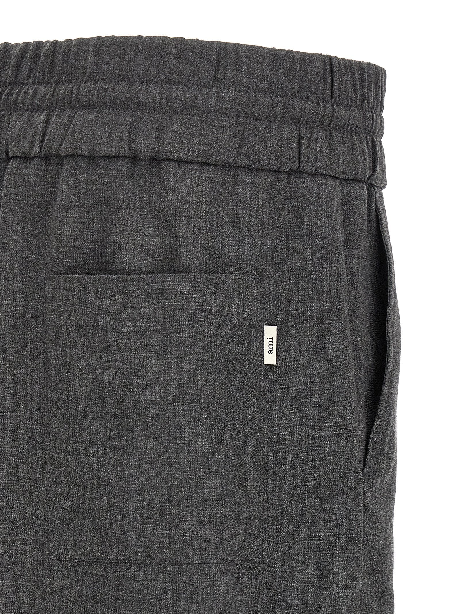 Trousers by Ami Paris for men in virgin wool gray & signature features a artisanal silhouette, showcasing a sophisticated relaxed-fit with a long and high rise for a artisanal finish.