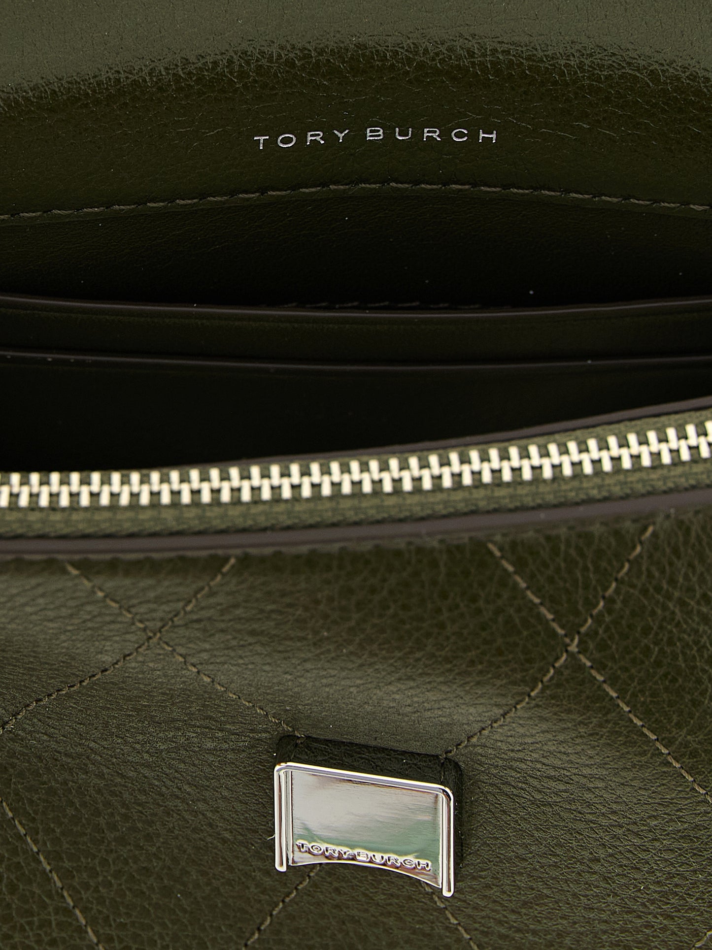 Mini Flap Handbag by Tory Burch for women in cowhide leather bicolour, green & signature features a contemporary silhouette, showcasing a secure flap, zipper & magnetic, ample , and contemporary shoulder-strap & handle for a sophisticated look.