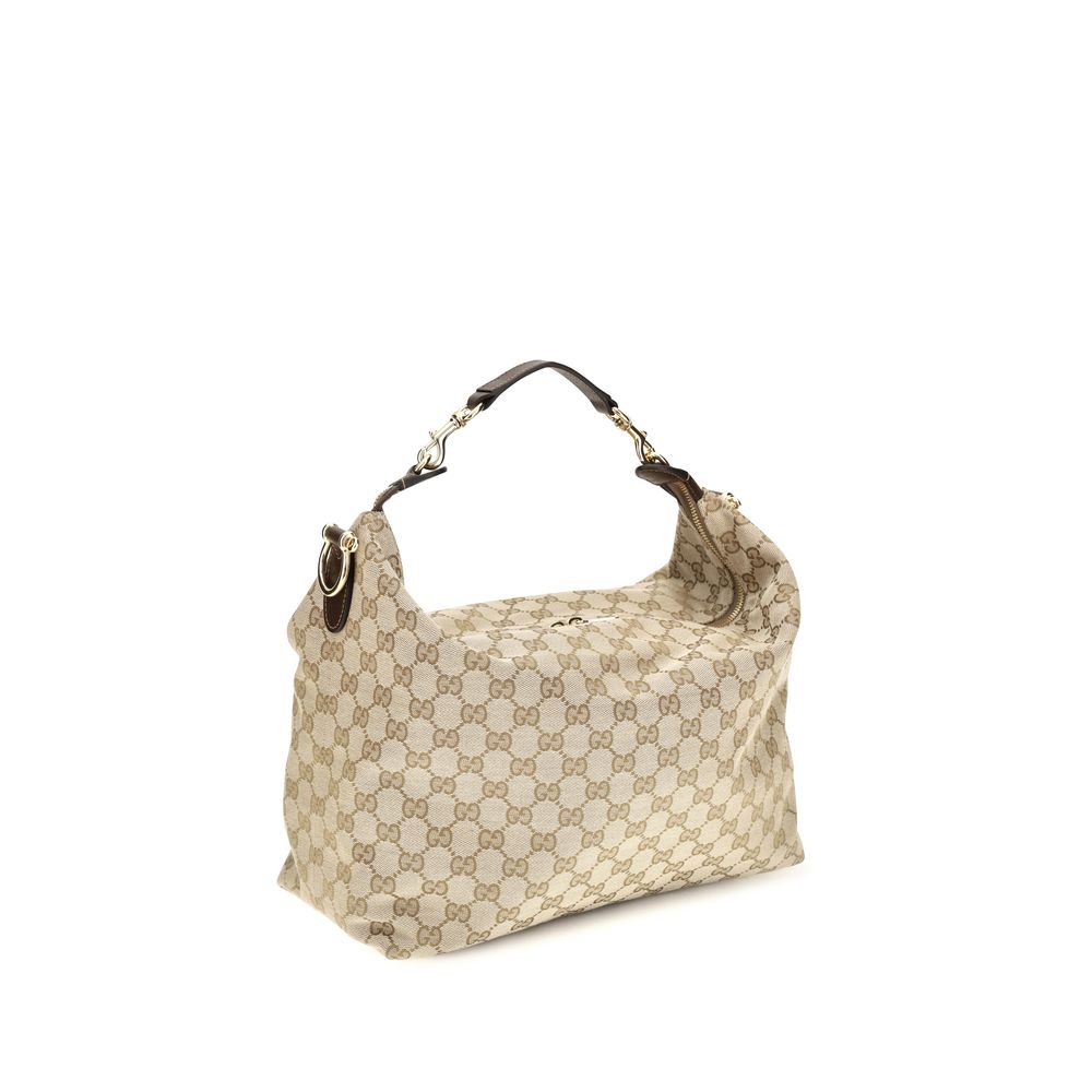 Medium Shoulder Bag by Gucci for men in nylon leather & canvas beige & gold features a effortless chic silhouette with a secure zipper, ample , and versatile shoulder-strap, adjustable-strap, detachable-strap & handle for a effortless chic finish.