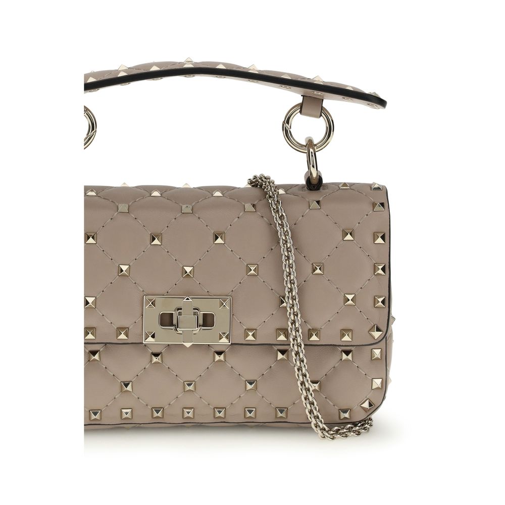 This Small Shoulder Handbag by Valentino Garavani for women in bos taurus calf leather and pink presents a sculptural silhouette featuring a secure , ample , and versatile shoulder-strap for a sculptural finish.