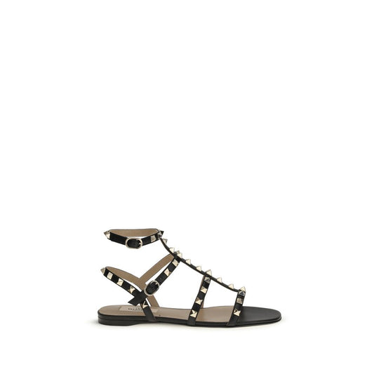 Flat Sandals by Valentino Garavani for women in bos taurus calf leather black features an exquisite silhouette, showcasing the exquisite Rockstud Women's Bos Taurus Calf Leather Flat Sandals with a flat and .