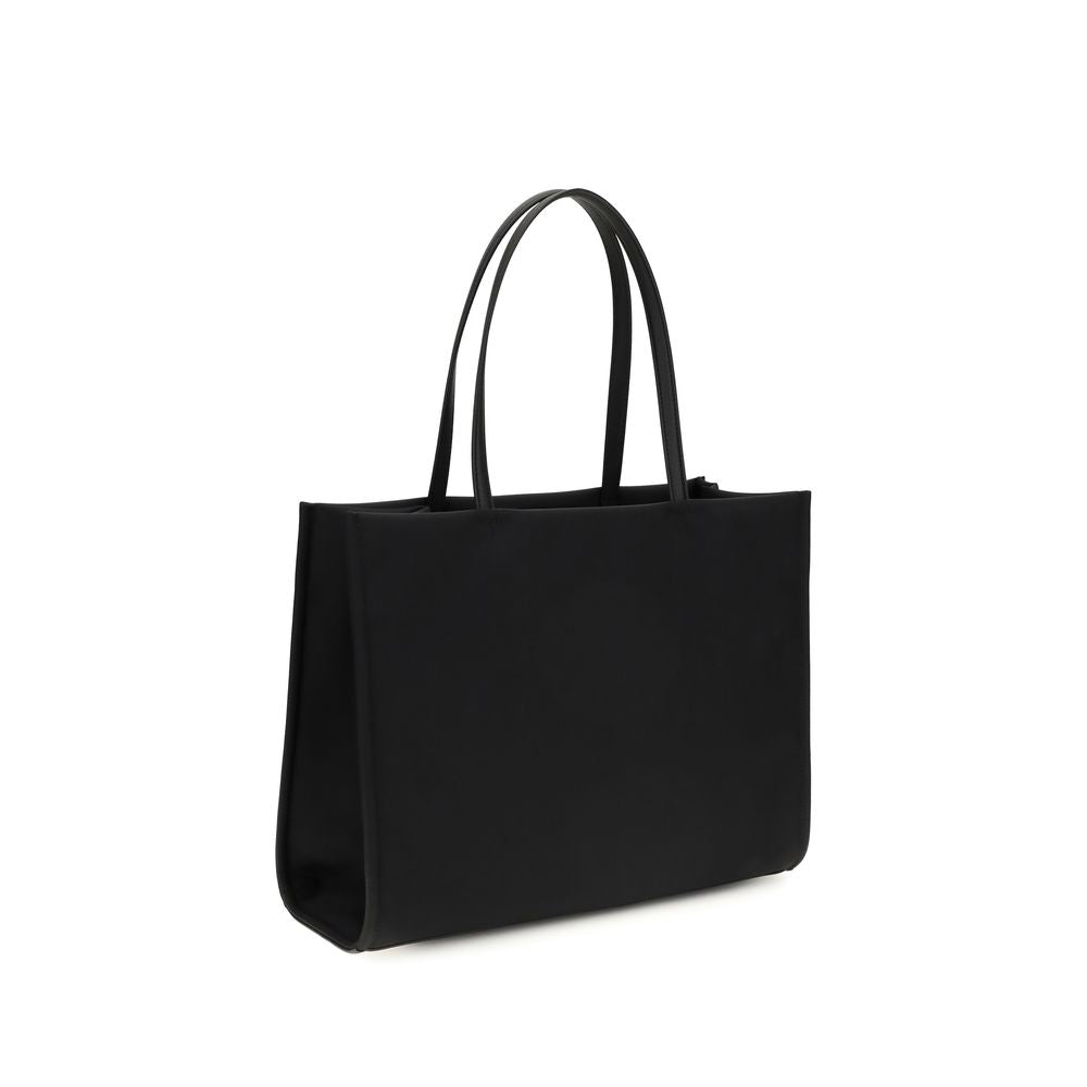 This Small Tote Handbag by Tory Burch for women in polyamide and black presents a sculptural silhouette featuring a secure , ample , and versatile for a sculptural finish.