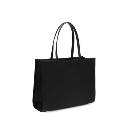 This Small Tote Handbag by Tory Burch for women in polyamide and black presents a sculptural silhouette featuring a secure , ample , and versatile for a sculptural finish.