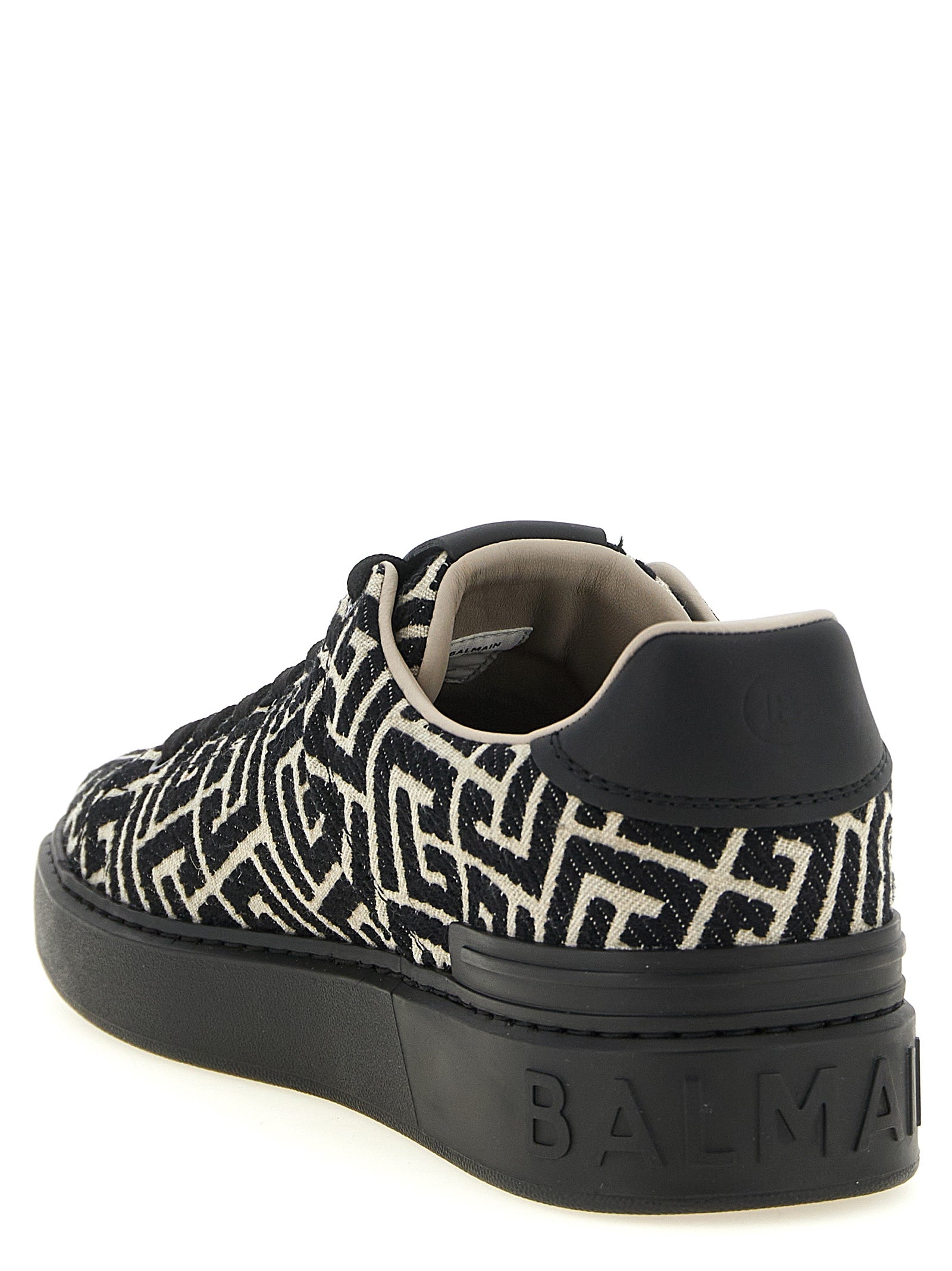 Sneakers by Balmain for men in polyester cotton leather bicolour, beige, black, white, jacquard & monogram presents a sumptuous silhouette, artfully capturing the essence of the Men's Low Top Polyester Cotton Leather Sneakers with its sumptuous low-top style design.