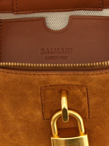 Vanity Handbag by Balmain for women in plush suede calfskin leather brown & gold features a exquisite silhouette, showcasing a secure zipper and exquisite with versatile shoulder-strap & handle for a exquisite finish.