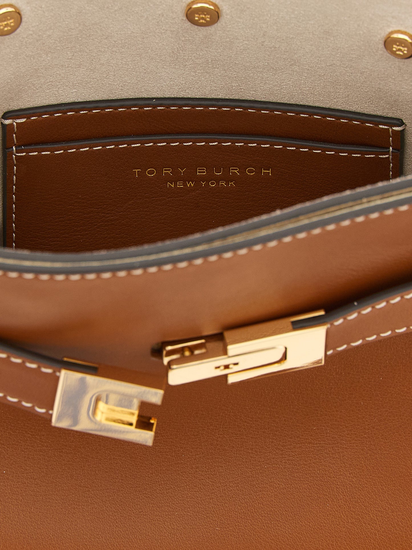 Compact Crossbody Handbag by Tory Burch for women in cowhide leather brown & gold features a transformative elegance silhouette, showcasing a secure , organized , and versatile crossbody-strap, shoulder-strap, handle, adjustable-strap, detachable-strap & belt-strap for a transformative elegance look.