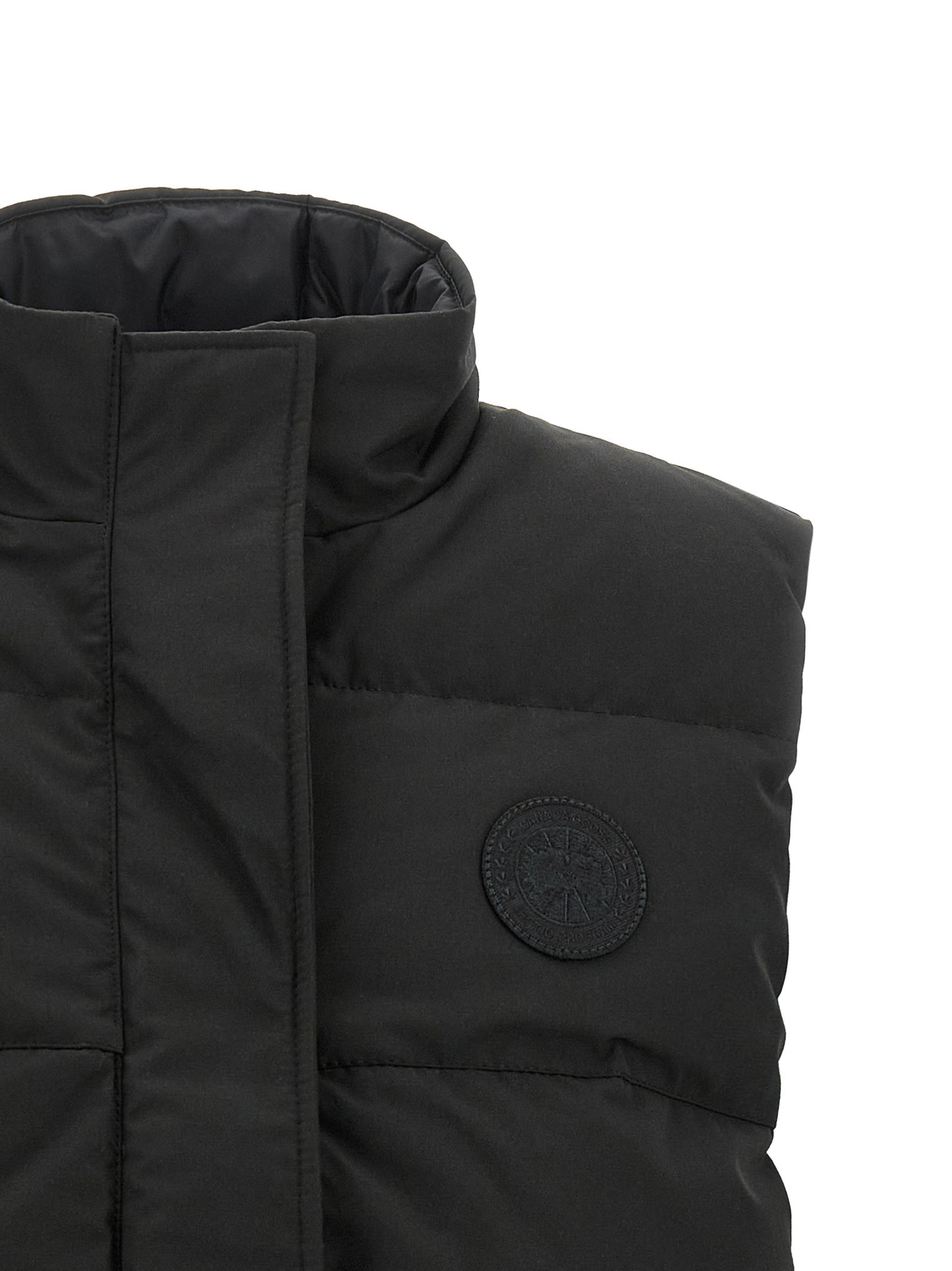Vest by Canada Goose for women in cotton polyester black showcases a dynamic silhouette, perfectly balancing thermal & pockets with a dynamic high-neck neckline for a sophisticated, high-fashion look.