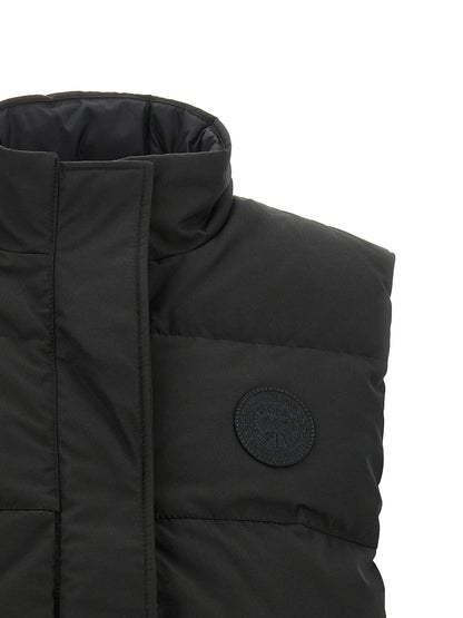 Vest by Canada Goose for women in cotton polyester black showcases a dynamic silhouette, perfectly balancing thermal & pockets with a dynamic high-neck neckline for a sophisticated, high-fashion look.