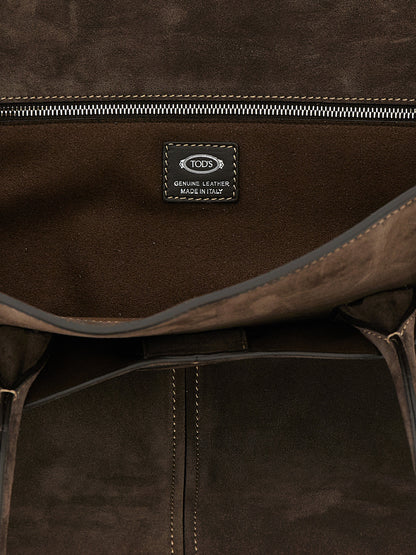 This Mountain Backpack Handbag by Tod's for women in bos taurus suede calfskin leather and brown presents a sculptural silhouette featuring a secure zipper, ample , and versatile handle for a sculptural finish.