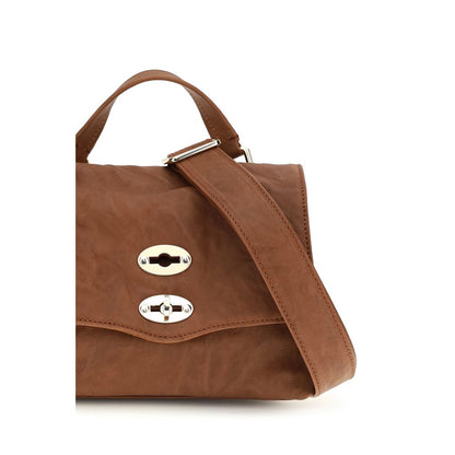 Shoulder Flap Bag by Zanellato for women in suede leather brown & signature features a distinguished silhouette, showcasing a secure flap, zipper & clasp and distinguished built-in-compartments with versatile shoulder-strap, handle & adjustable-strap for a distinguished finish.