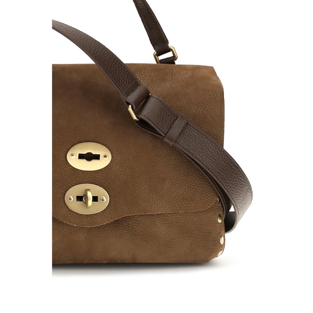 Shoulder Flap Bag by Zanellato for women in suede calf leather brown features a effortless sophistication silhouette, secured by a flap with ample and versatile shoulder-strap & handle for a effortless sophistication finish.