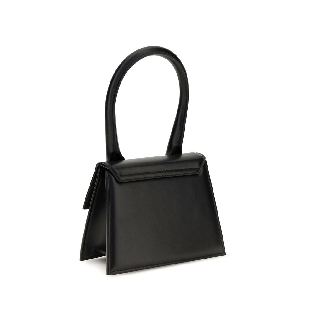 Compact Flap Handbag by Jacquemus for women in bos taurus calf leather black & gold presents a ornamental silhouette, showcasing a secure flap & magnetic, ample , and versatile shoulder-strap & handle for a ornamental finish.