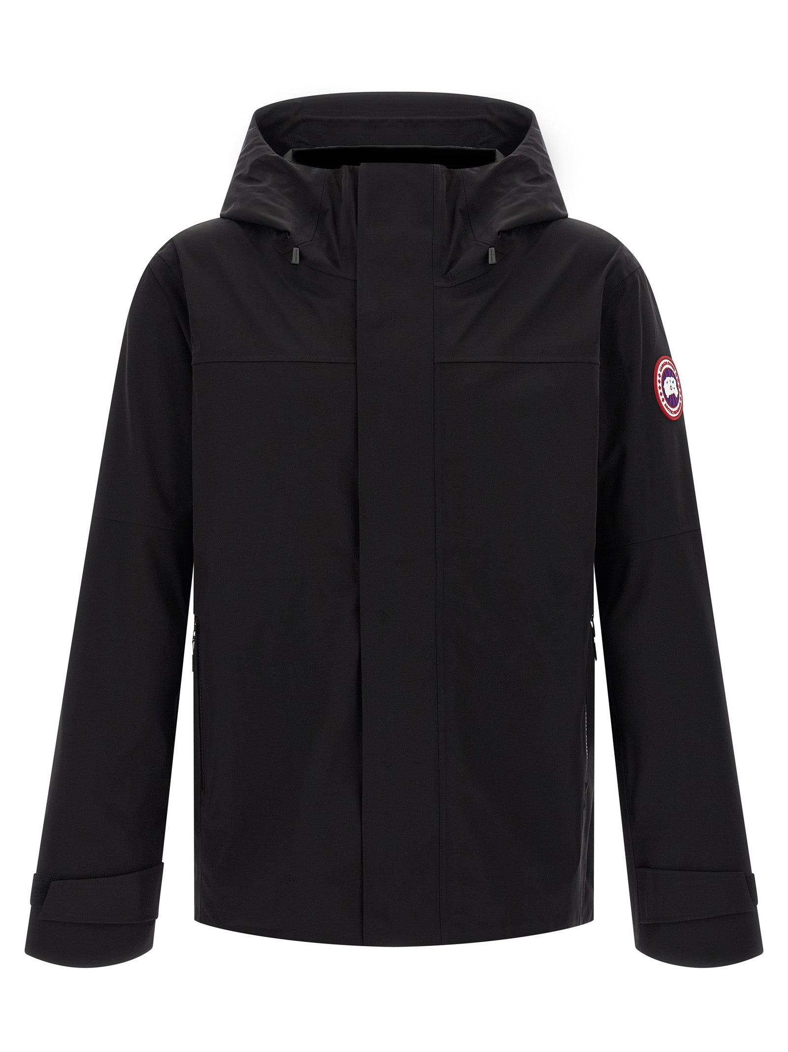 Hooded Rain Coat by Canada Goose for men in stretch polyamide black features an impenetrable silhouette, perfectly blending water-resistant, pockets, hooded & windproof with a sophisticated hooded neckline for a impenetrable finish.