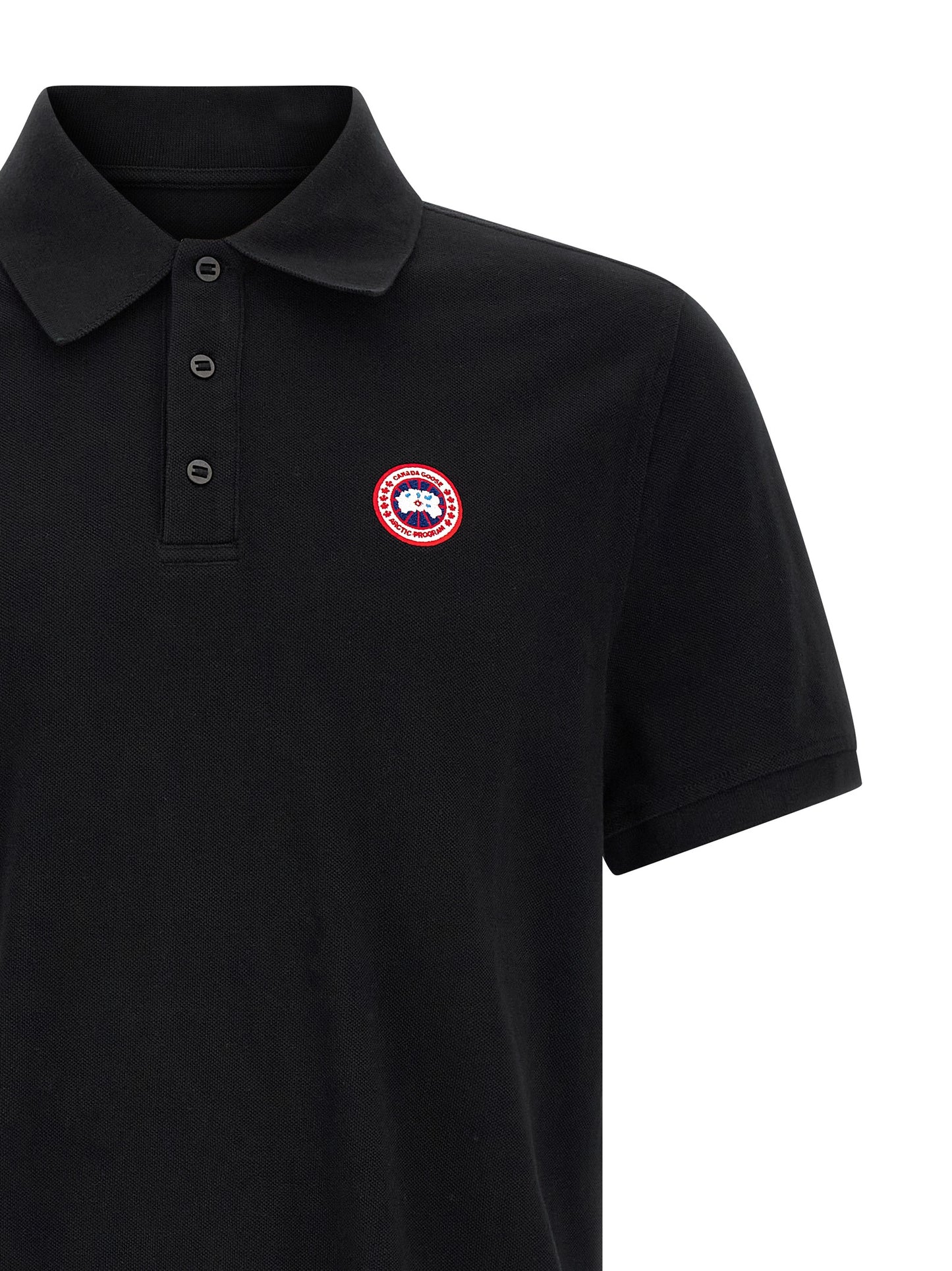 Polo Shirt by Canada Goose for women in cotton black presents a crisp silhouette, artfully detailed with a crisp and crisp asymmetric neckline.