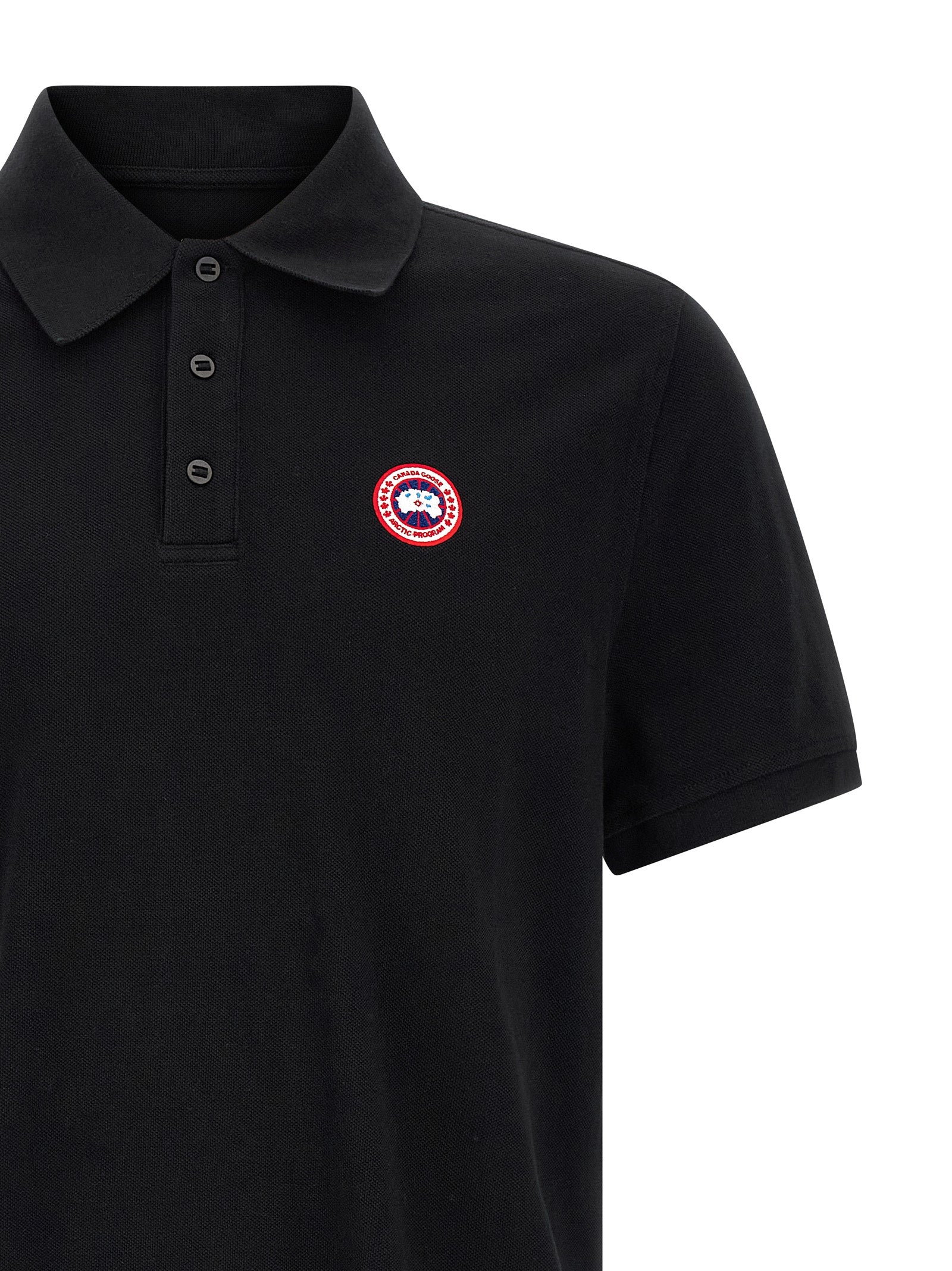 Polo Shirt by Canada Goose for women in cotton black presents a crisp silhouette, artfully detailed with a crisp and crisp asymmetric neckline.