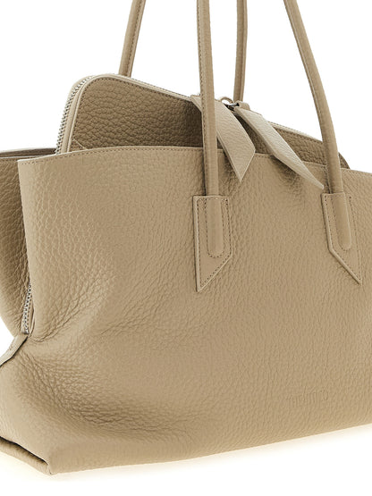 Medium Shoulder Bag by The Attico for women in bos taurus suede calf leather beige & sand features a distinguished silhouette, showcasing a secure zipper and distinguished with versatile shoulder-strap & handle for a distinguished finish.