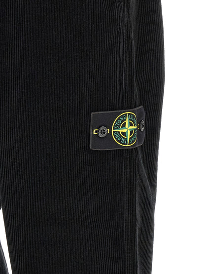 Trousers by Stone Island for men in organic cotton corduroy black features a tailored silhouette with a tailored , defined by its long and a sophisticated .