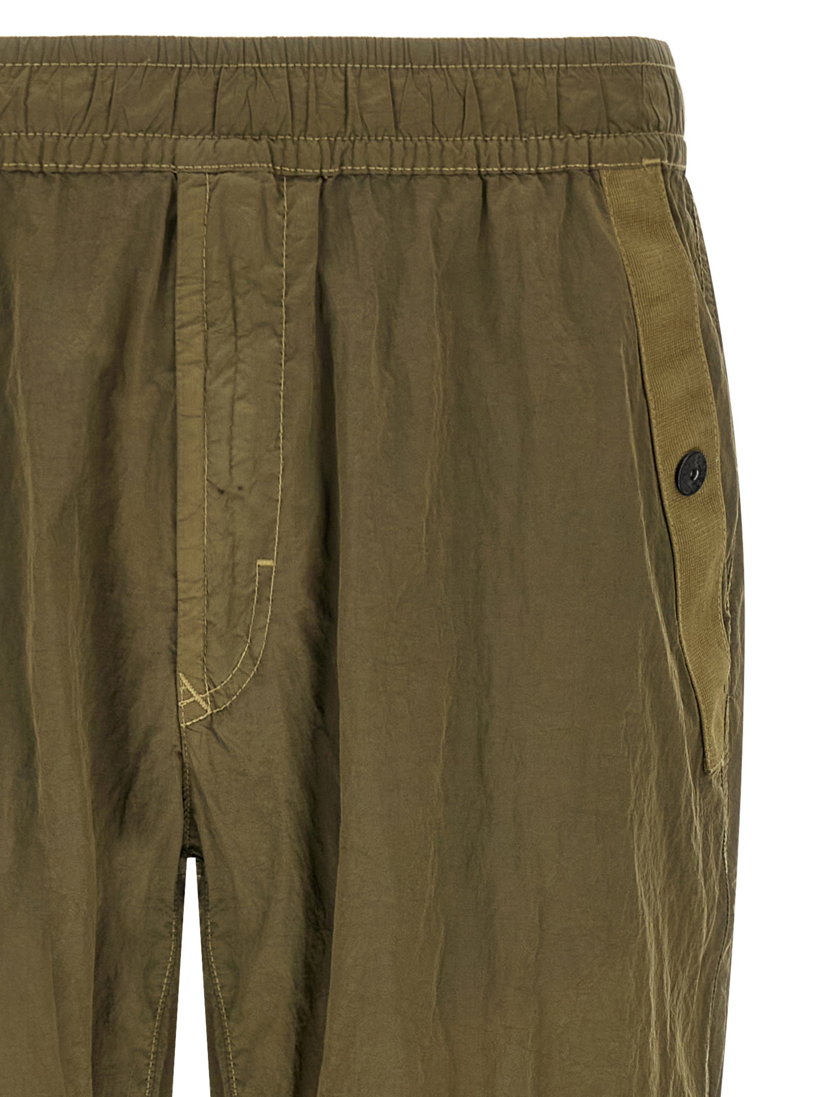 Joggers by Stone Island for men in nylon bicolour, green & olive presents a tailored silhouette, showcasing a tailored athletic and long cut with a refined for a truly tailored aesthetic.