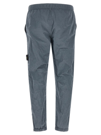 Joggers by Stone Island for men in nylon gray features a refined silhouette with a refined , defined by a and a refined long for a refined finish.
