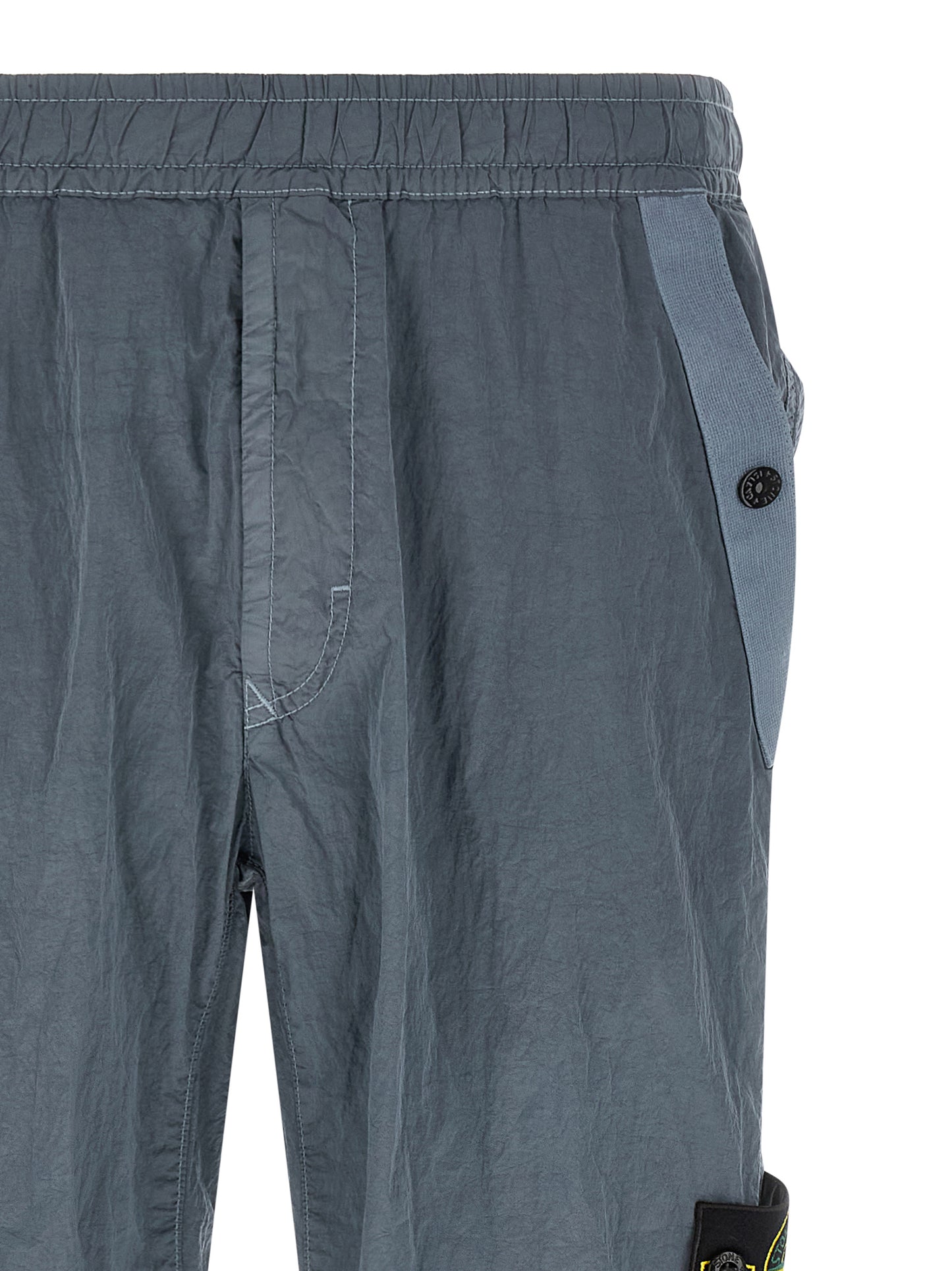 Joggers by Stone Island for men in nylon gray features a polished silhouette with a polished , reaching a polished long and finished with a polished .