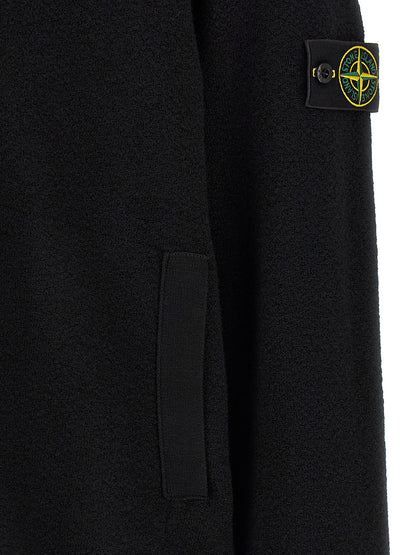 Cardigan by Stone Island for men in virgin wool black features a dramatic silhouette, showcasing a sophisticated and dramatic detail for a timeless, premium look.