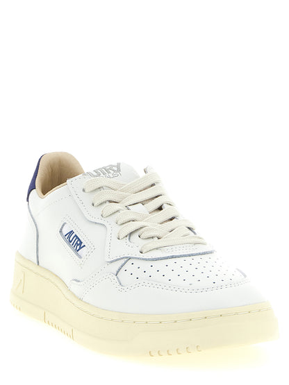 Athletic Sneakers by Autry for men in bos taurus suede cowhide leather cream, dark-blue & white showcases a architectural silhouette, artfully capturing the essence of the Men's Low Top Bos Taurus Suede Cowhide Leather Athletic Sneakers with its signature architectural low-top style construction.