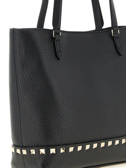 Small Shoulder Tote Bag by Valentino Garavani for women in calfskin leather black features a effortless sophistication silhouette, secured by a zipper with ample and versatile shoulder-strap, handle, adjustable-strap & detachable-strap for a effortless sophistication finish.