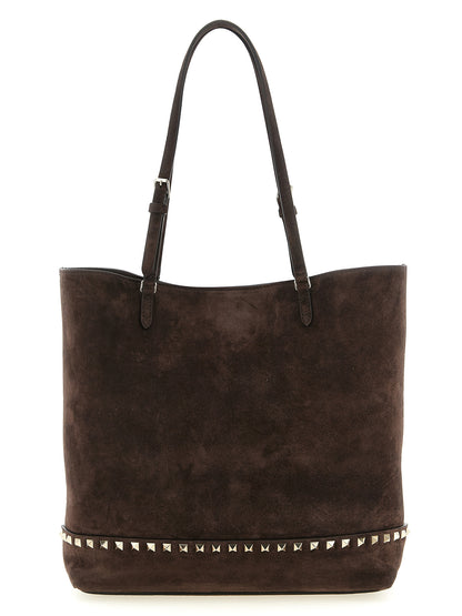 Medium Shoulder Tote Bag by Valentino Garavani for women in suede calfskin leather brown showcases a enviable silhouette, artfully detailed with a secure zipper, magnetic & buckle, organized , and versatile shoulder-strap, adjustable-strap & handle for a enviable look.