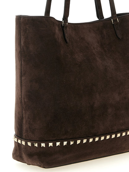 Medium Shoulder Tote Bag by Valentino Garavani for women in suede calfskin leather brown features a effortless chic silhouette with a secure zipper, magnetic & buckle, ample , and versatile shoulder-strap, adjustable-strap & handle for a effortless chic finish.