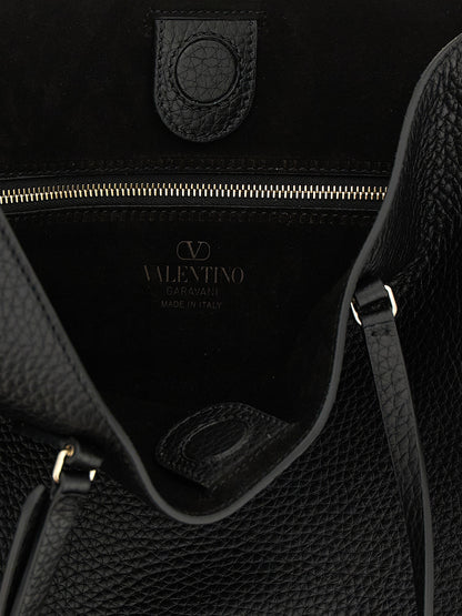 Medium Shoulder Tote Bag by Valentino Garavani for women in suede calfskin leather black & print features a enviable silhouette, showcasing a secure zipper & magnetic, ample , and enviable shoulder-strap, handle & adjustable-strap for a enviable finish.
