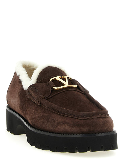 Flat Loafer Slip-On Shoes by Valentino Garavani for women in suede calfskin leather brown, gold & signature showcases a impeccable silhouette as V Logo Women's Suede Calfskin Leather Flat Loafer Slip-On Shoes, artfully designed with a impeccable flat and refined for a impeccable finish.