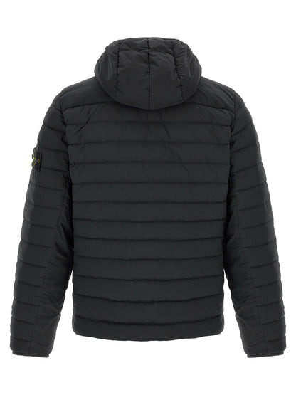 Hooded Puffer Jacket by Stone Island for men in stretch polyamide black presents a effortlessly chic silhouette, showcasing a sophisticated hooded high-neck neckline and premium lightweight, pockets, hooded, insulated & windproof for a truly effortlessly chic finish.