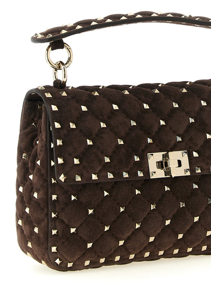 2-in-1 Shoulder & Crossbody Handbag by Valentino Garavani for women in suede calfskin leather brown features an multi-faceted design with a secure zipper, ample , and versatile crossbody-strap, shoulder-strap & handle for a multi-faceted finish.
