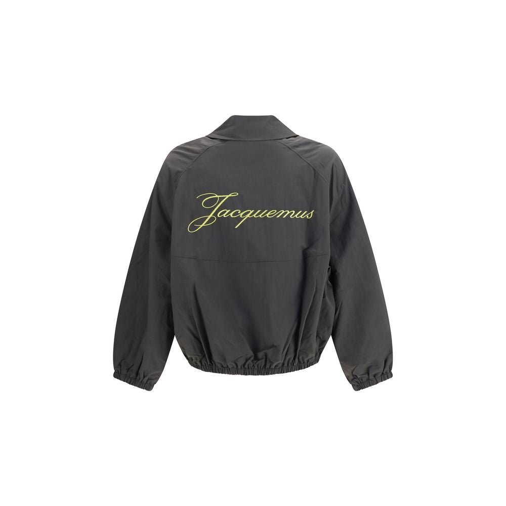 Overcoat by Jacquemus for men in polyamide & polyurethane gray showcases a enveloping silhouette, detailed with distinctive and a enveloping .