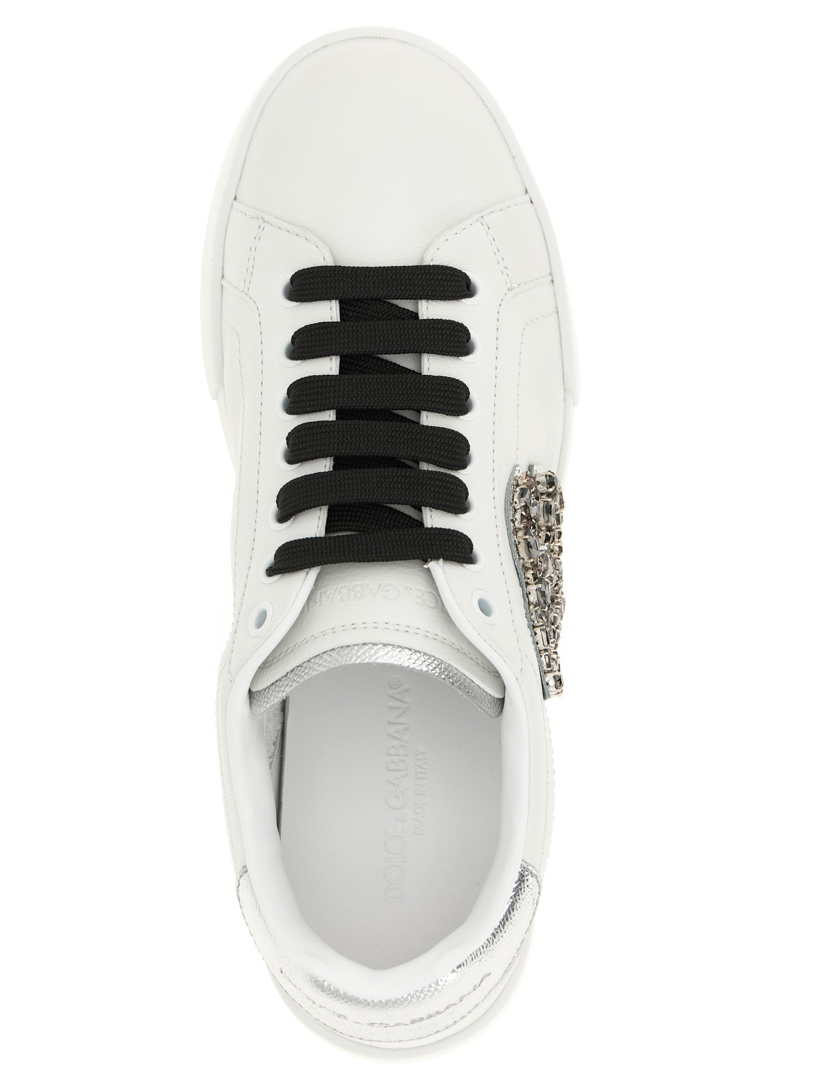 Sneakers by Dolce & Gabbana for women in dauphine calfskin leather black & silver presents a sumptuous silhouette, artfully capturing the essence of the Women's Low Top Dauphine Calfskin Leather Sneakers with its sumptuous low-top style design.