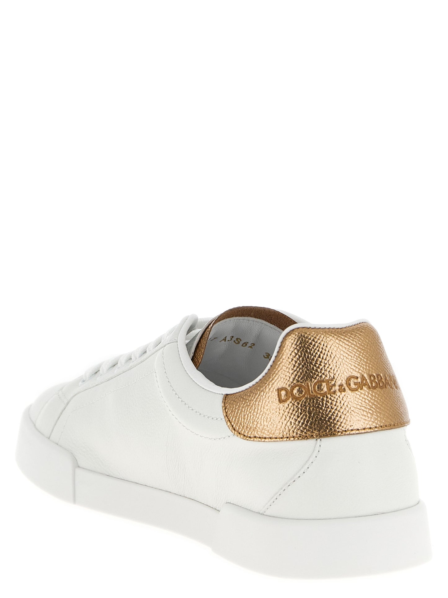 Sneakers by Dolce & Gabbana for women in dauphine calfskin leather gold & signature presents a sumptuous silhouette, artfully capturing the essence of the Women's Low Top Dauphine Calfskin Leather Sneakers with its sumptuous low-top style design.