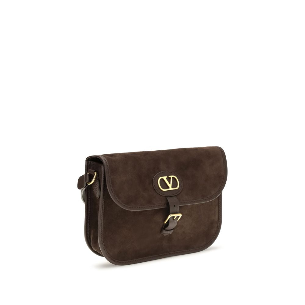 Shoulder Flap Bag by Valentino Garavani for men in bos taurus suede calf leather brown & signature features a distinguished silhouette, showcasing a secure flap, zipper & buckle and distinguished with versatile shoulder-strap & adjustable-strap for a distinguished finish.