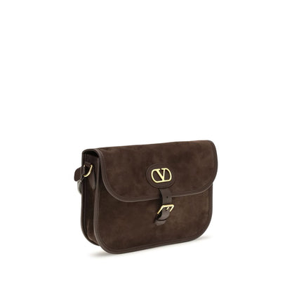 Shoulder Flap Bag by Valentino Garavani for men in bos taurus suede calf leather brown & signature features a distinguished silhouette, showcasing a secure flap, zipper & buckle and distinguished with versatile shoulder-strap & adjustable-strap for a distinguished finish.