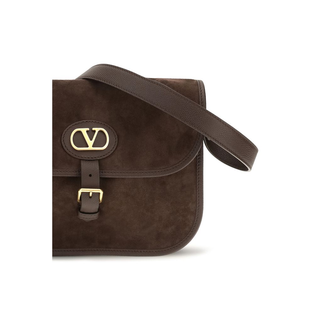 Shoulder Flap Bag by Valentino Garavani for men in bos taurus suede calf leather brown & signature features a effortless sophistication silhouette, secured by a flap, zipper & buckle with ample and versatile shoulder-strap & adjustable-strap for a effortless sophistication finish.