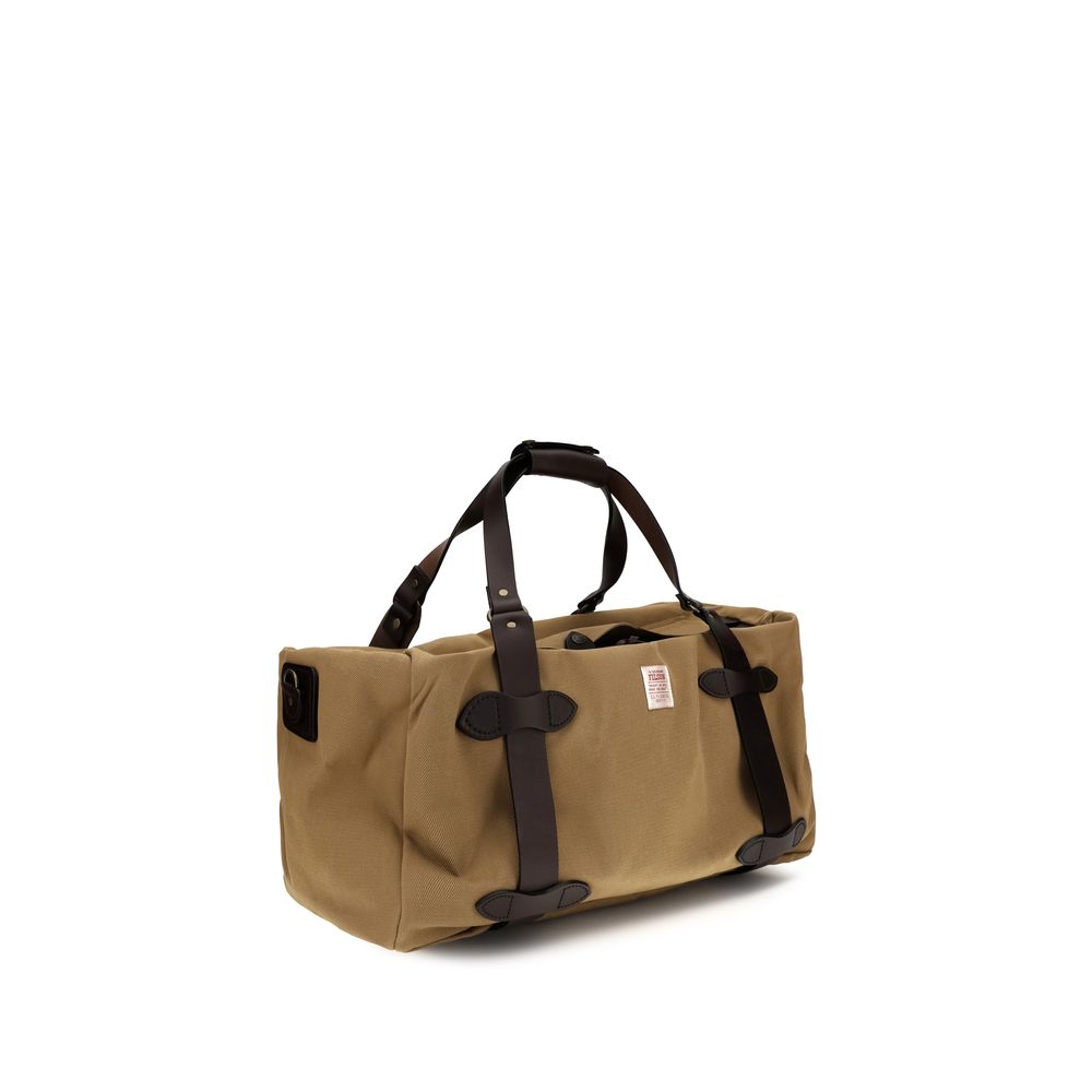 Medium Shoulder Tote Bag by Filson for men in cotton twill beige features a distinguished silhouette, showcasing a secure snap & zipper and distinguished internal-pockets with versatile shoulder-strap, adjustable-strap & handle for a distinguished finish.