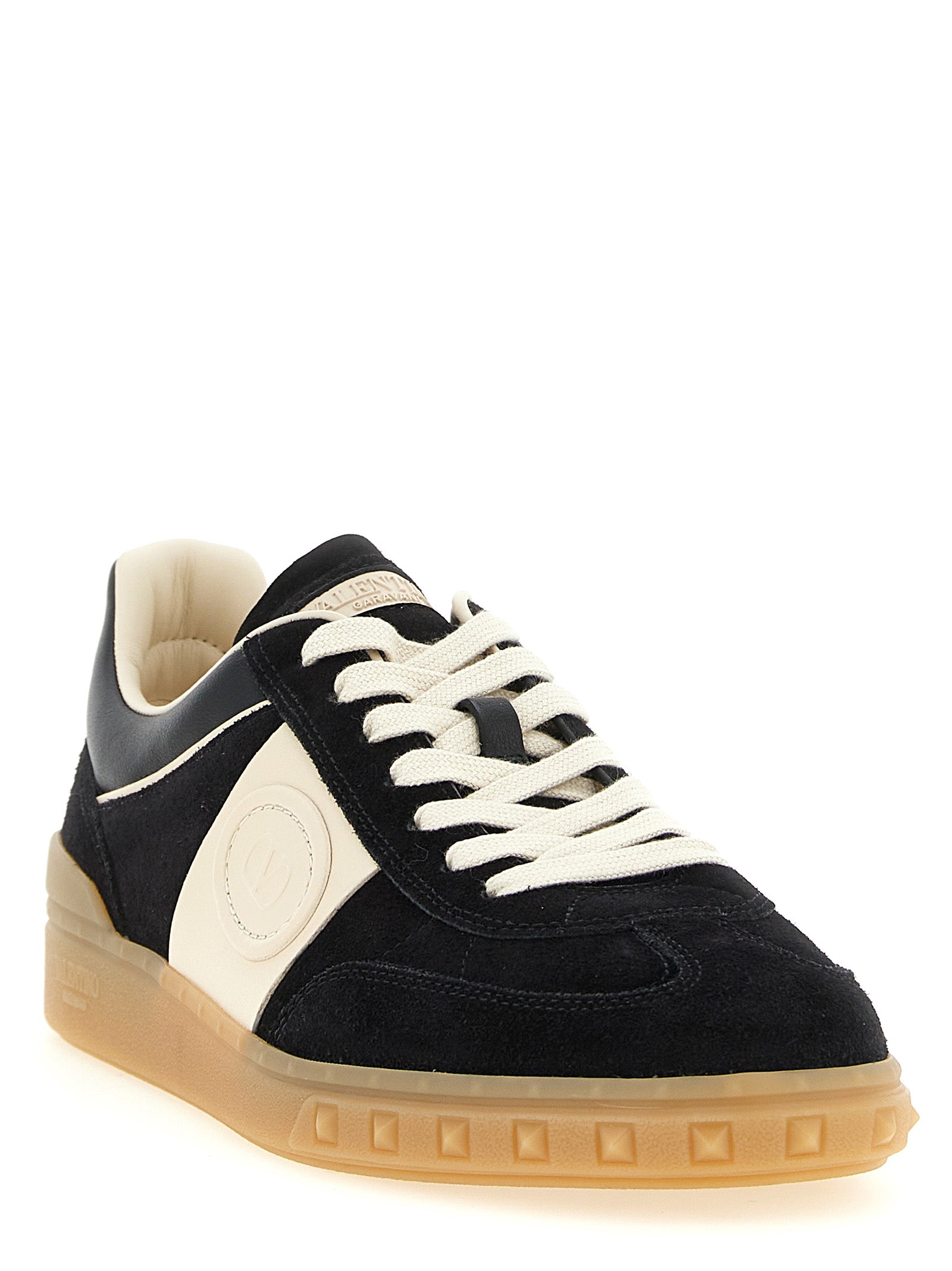 Sneakers by Valentino Garavani for men in bos taurus suede calfskin leather black, cream, multicolor & signature presents a impeccable silhouette as Rockstud V Logo Men's Low Top Bos Taurus Suede Calfskin Leather Sneakers, expertly defined by a impeccable low-top style for a impeccable, high-fashion look.