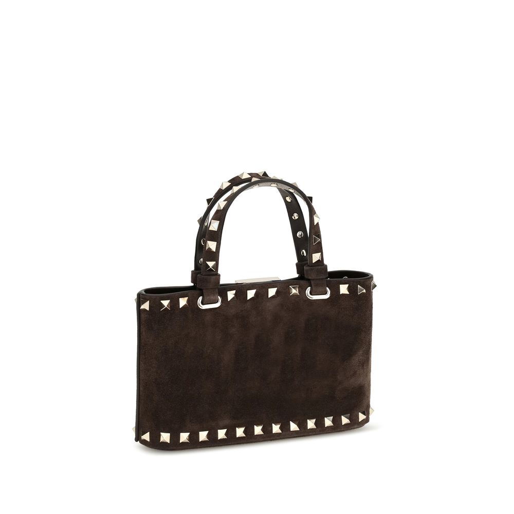 This Mini Shopper Handbag by Valentino Garavani for women in bos taurus calf suede leather and brown presents a sculptural silhouette featuring a secure hook, ample , and versatile handle for a sculptural finish.