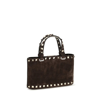 This Mini Shopper Handbag by Valentino Garavani for women in bos taurus calf suede leather and brown presents a sculptural silhouette featuring a secure hook, ample , and versatile handle for a sculptural finish.