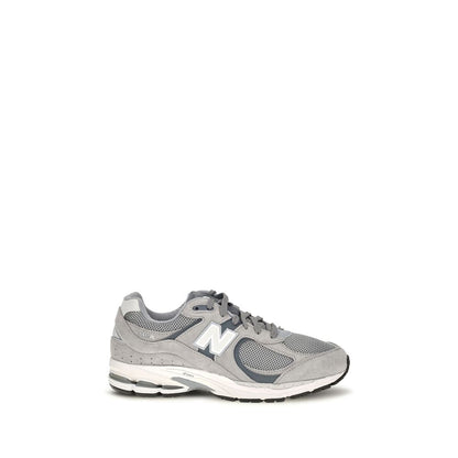 Athletic Sneakers by New Balance for men in polyester & rubber gray, signature & monogram presents a sleek silhouette, perfectly capturing the athletic style essence of Men's Athletic Polyester & Rubber Sneakers with its sleek design and premium finish.
