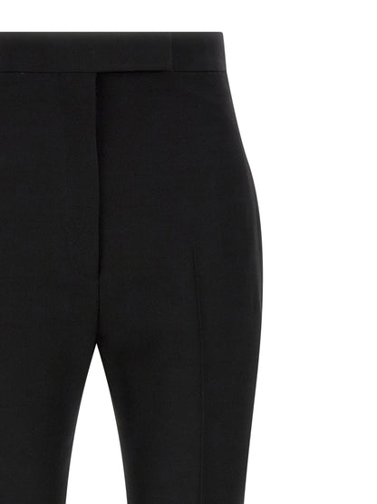 Trousers by Tom Ford for women in satin wool black presents a smart silhouette, meticulously detailed with a smart straight & slim, a smart long, and a smart high rise.