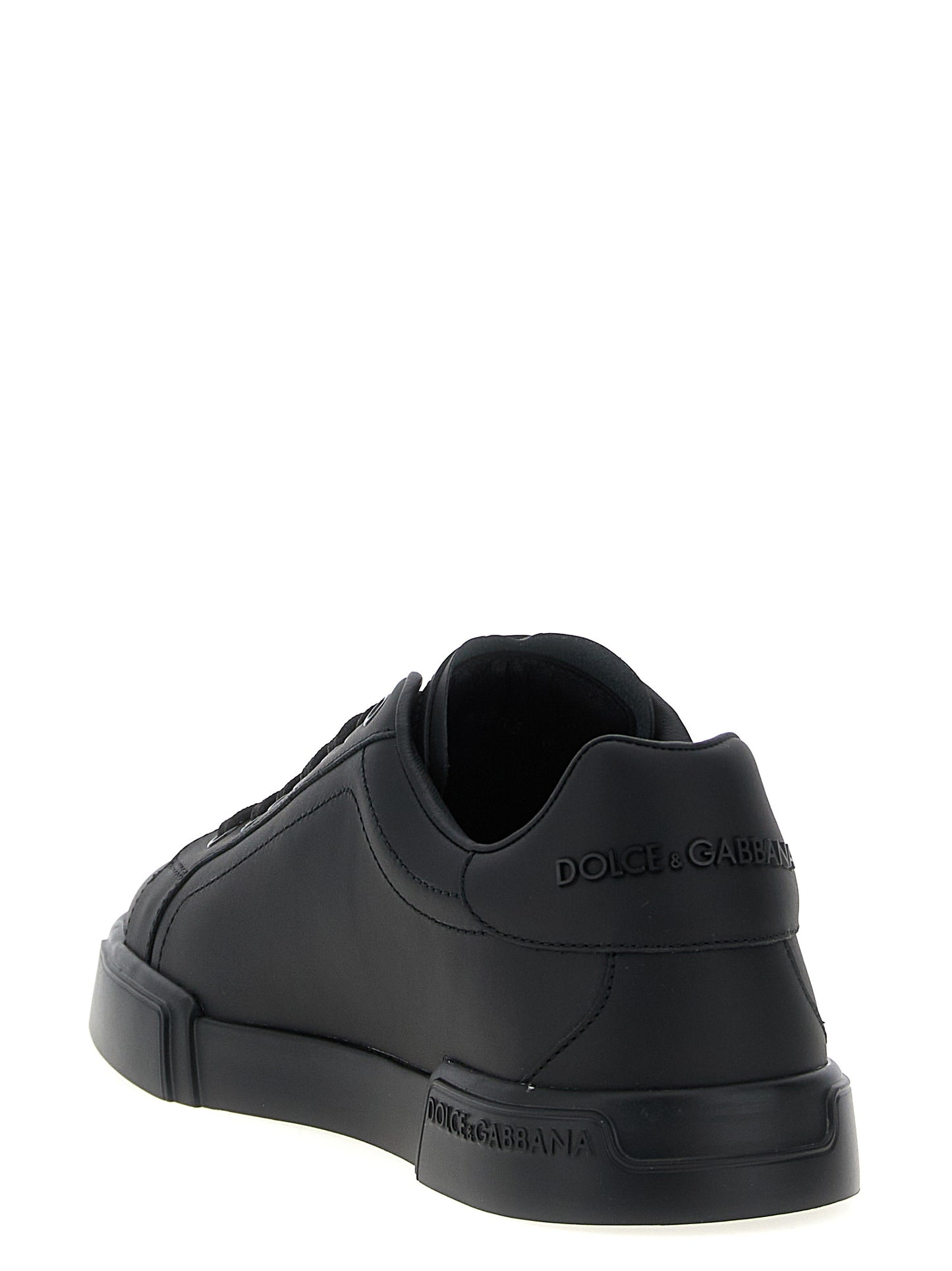 Sneakers by Dolce & Gabbana for men in calfskin leather black presents a sumptuous silhouette, artfully capturing the essence of the Men's Low Top Calfskin Leather Sneakers with its sumptuous low-top style design.