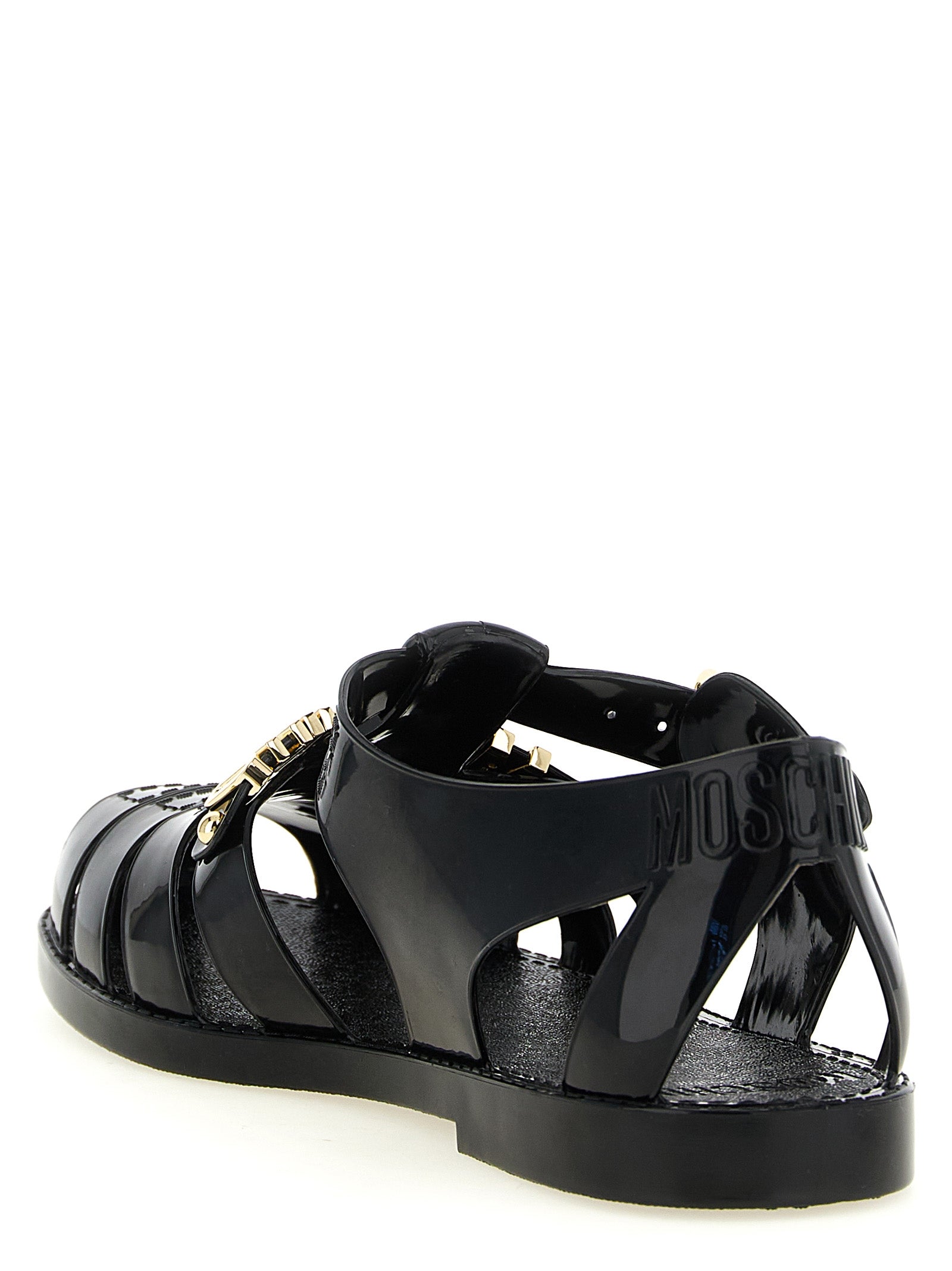 Flat Ankle Strap Cage Fisherman Sandals by Moschino for men in pvc black & gold showcases a sculptural silhouette as Men's PVC Flat Ankle Strap Cage Fisherman Sandals, defined by a sculptural flat and sculptural for a sculptural look.
