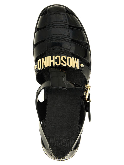 Flat Ankle Strap Cage Fisherman Sandals by Moschino for men in pvc black & gold features an effortlessly chic silhouette from the Men's PVC Flat Ankle Strap Cage Fisherman Sandals collection, showcasing a effortlessly chic flat and elegant .
