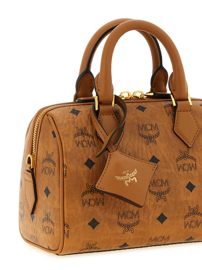 Travel Belt Pouch Handbag by MCM for women in polyester polyethylene polyurethane leather brown, gold & monogram features an refined silhouette, showcasing a secure , ample , and versatile shoulder-strap, adjustable-strap, detachable-strap & handle for a sophisticated refined aesthetic.